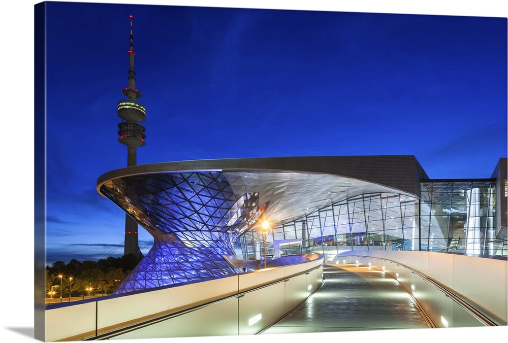 Germany, Bavaria, Munich, BMW Welt company showroom and Olympia Tower, dusk.