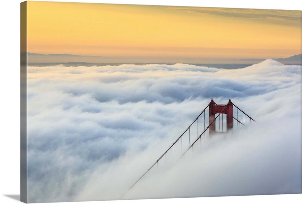 Golden Gate Bridge emerging from the morning fog at sunrise. San Francisco, Marin County, California, USA.