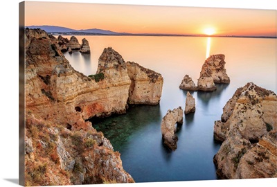 Golden sunrise on the red cliffs of Ponta da Piedade Lagos Algarve Portugal
