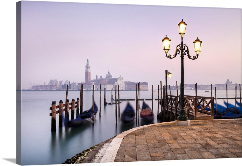 Gondolas on the lagoon at dawn, with San Giorgio Maggiore in the background, San Marco, Venice, Italy