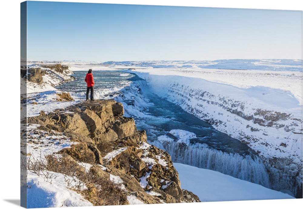 Gullfoss waterfall, Golden Circle, Iceland. Man with red coat admiring the waterfall.