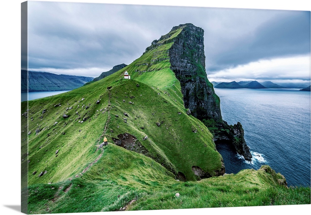Hiker near the Kalsoy Lighthouse, Faroe Islands, Europe.