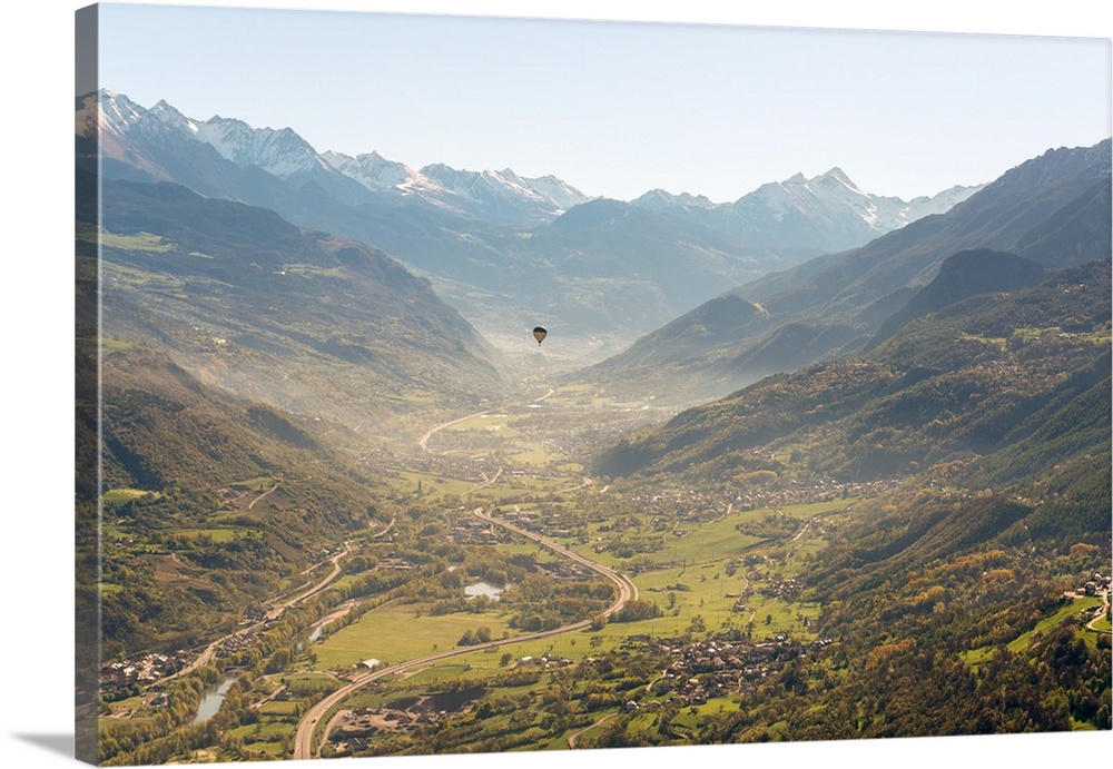 hot air balloon flies over Aosta city, Valle d'Aosta, Italy, Europe.