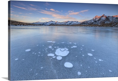 Ice bubbles on the frozen surface of Andossi Lake, Italy