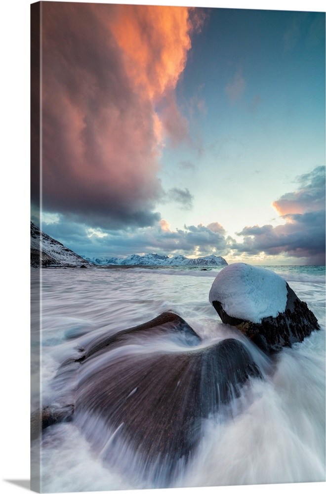 Ice on rocks in the rough sea, Vikten, Flakstad municipality, Lofoten Islands, Norway.