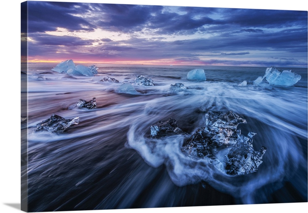 Icebergs being washed ashore on Breidamerkursandur black sands, near Jokulsarlon glacial lagoon, East Iceland