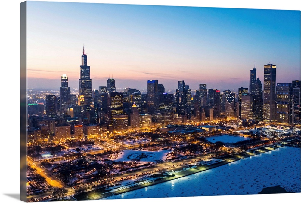 USA, Illinois, Chicago. Aerial dusk view of the city and Millennium Park in winter.