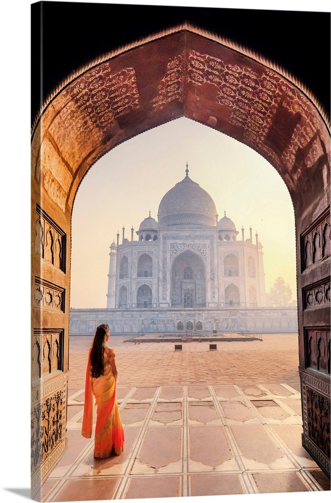 India, A Beautiful Woman In A Red And Yellow Sari In Front Of The Taj Mahal At Sunrise