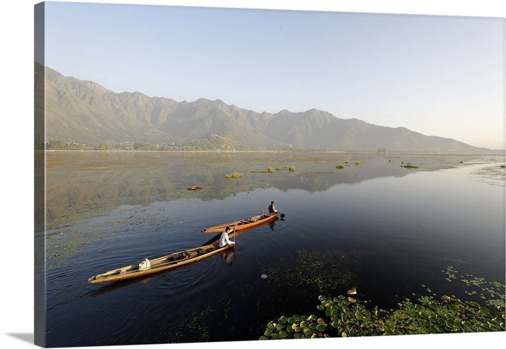 India, Jammu and Kashmir, Srinagar, Dal Lake. Locals take small pleasure boats on the placcid waters of Dal Lake which is ...