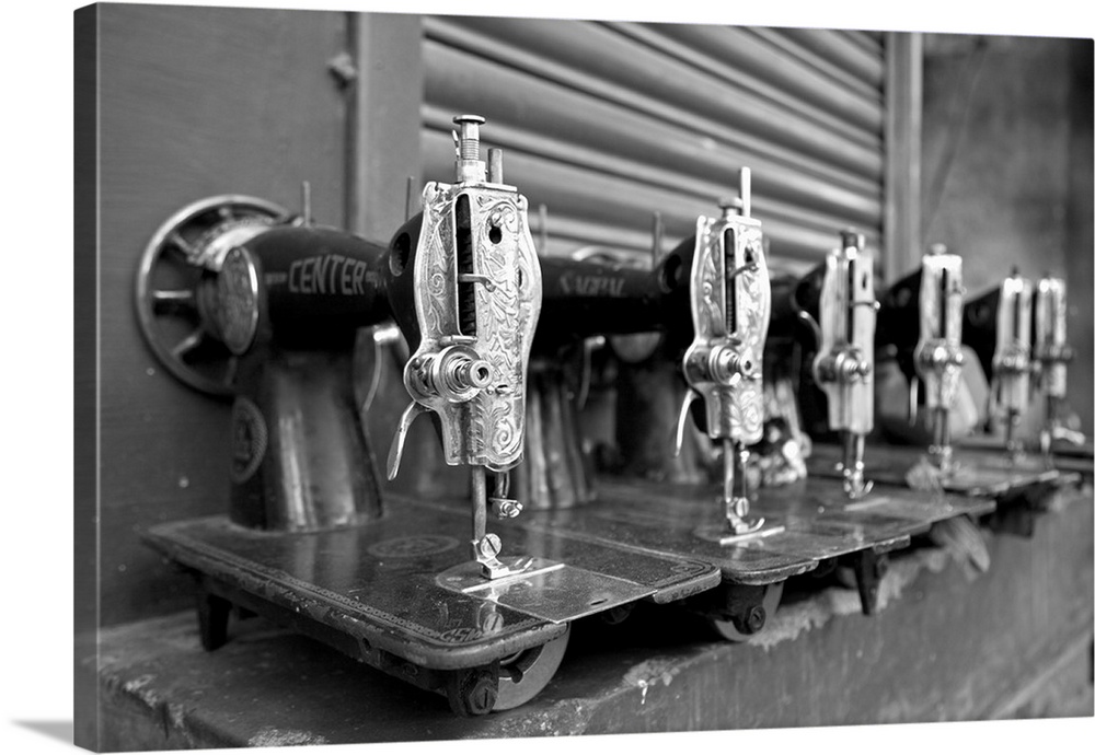 India, Mysore. Recently-repaired sewing machines lined up outside a sewing-machine repair shop in Mysore.