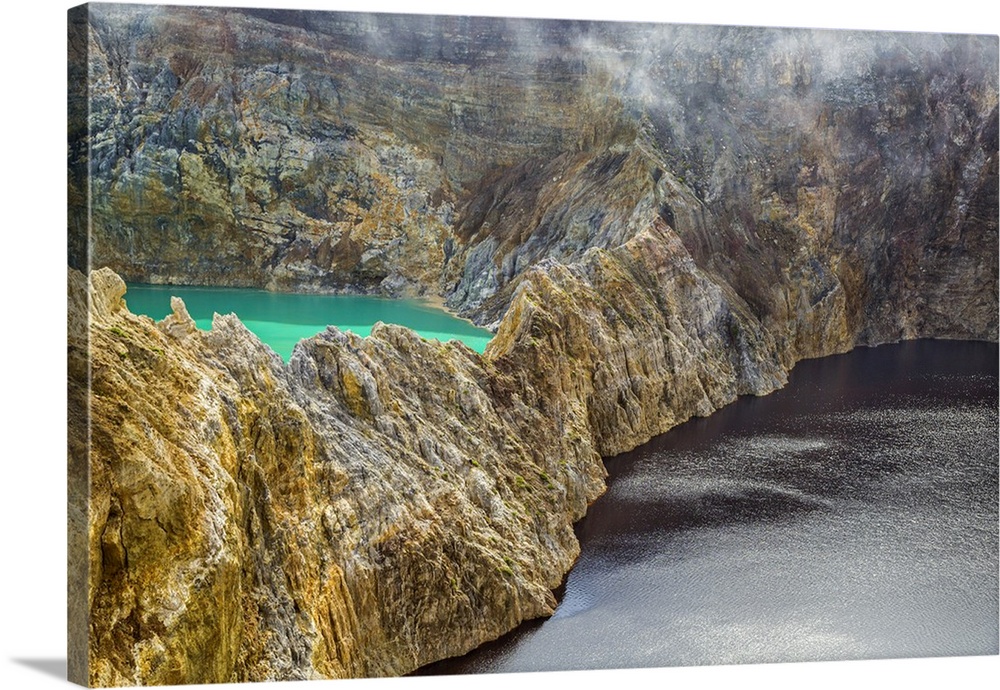 Indonesia, Flores Island, Moni. Low clouds lift to reveal two of the stunning crater lakes of Mount Kelimutu, a dormant vo...