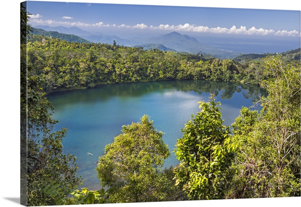 Indonesia, Flores Island, Ruteng. Surrounded by forest, the attractive volcanic crater lake of Rane Mesi is situated betwe...