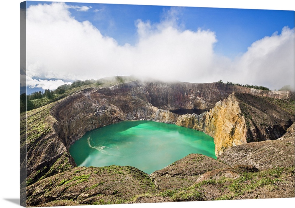 Indonesia, Flores Island, Moni. Low clouds lift to reveal two of the stunning crater lakes of Mount Kelimutu, a dormant vo...