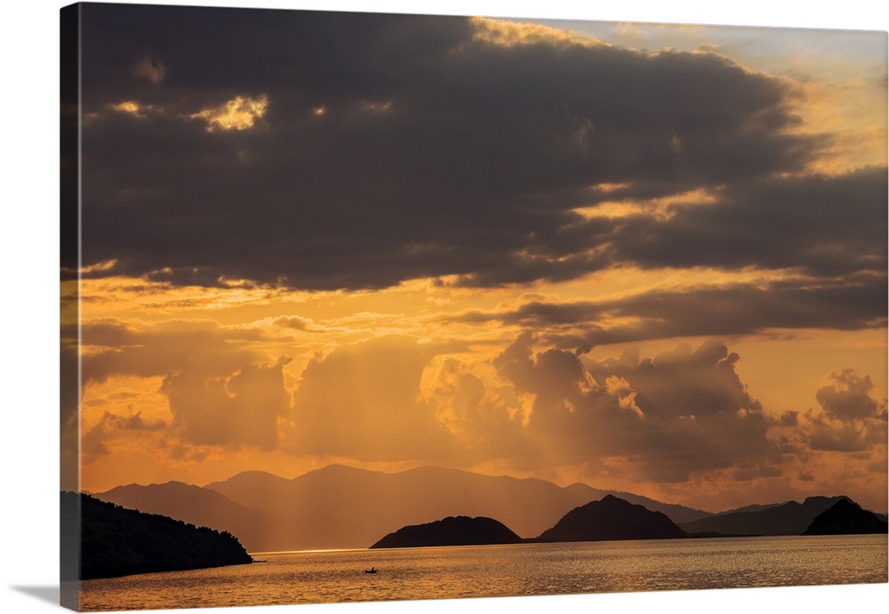 Indonesia, Lesser Sunda Islands, Rinca. Sunset over Komodo Island.