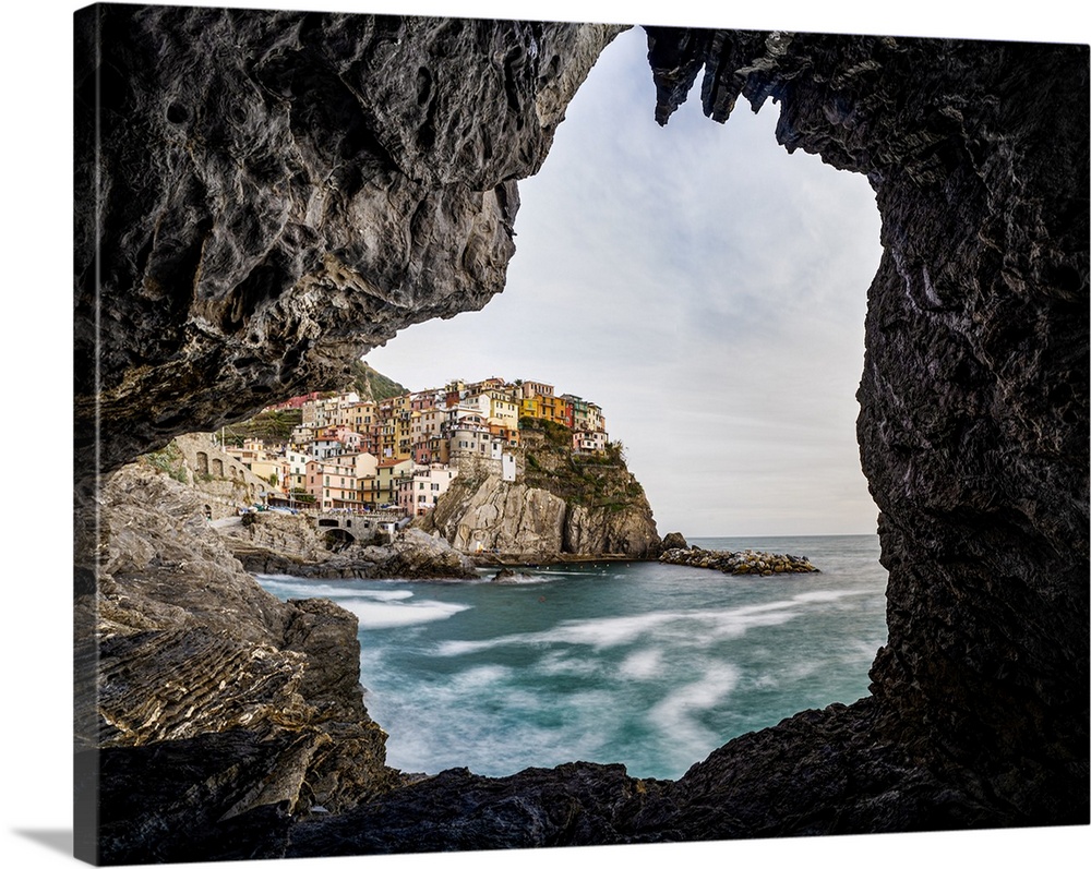 Italy, Liguria: Manarola from a cave on the shore.