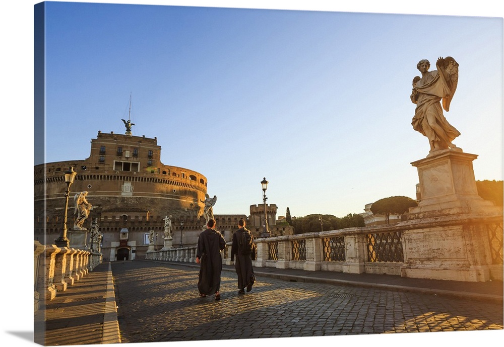 Italy, Rome, two monks walking at Mausoleum of Hadrian (known as Castel Sant'Angelo)  at sunrise