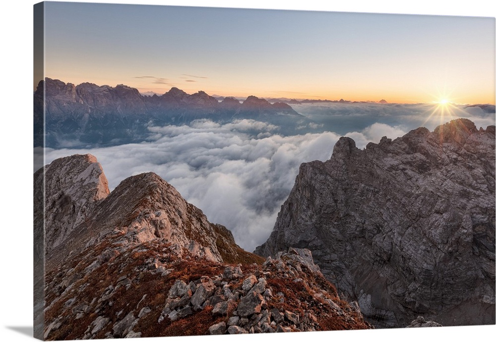 Europe, Italy, Veneto, Cadore, Auronzo. Sunrise with sea of clouds from Camosci peak, Marmarole, Sexten Dolomites in the b...