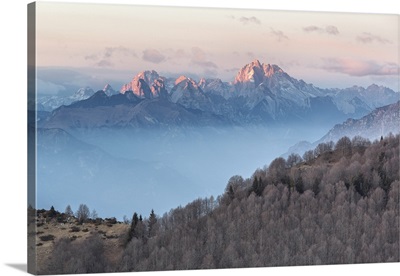 Italy, Veneto, Treviso, Cansiglio. View towards the Dolomites at sunset