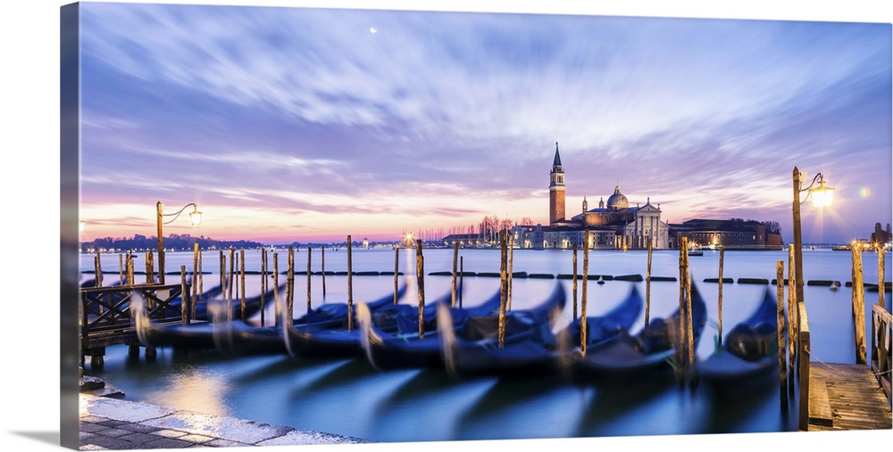 Italy, Veneto, Venice. Row of gondolas moored at sunrise on Riva degli Schiavoni