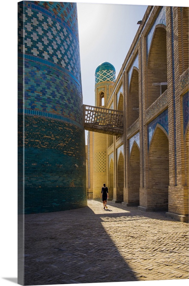 Kalta Minor minaret, Khiva. Uzbekistan, Central Asia. Woman walking near the minaret.