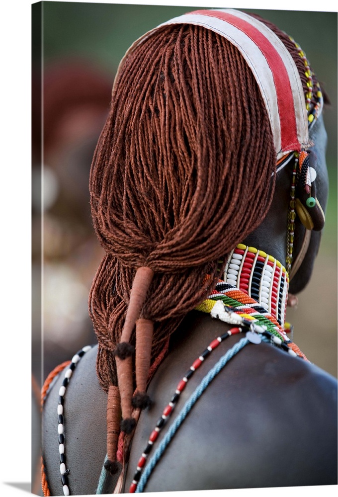 Kenya, Laikipia, Ol Malo. A Samburu warrior's hair is ochred and tied up in braids at a dance at a local manyatta.