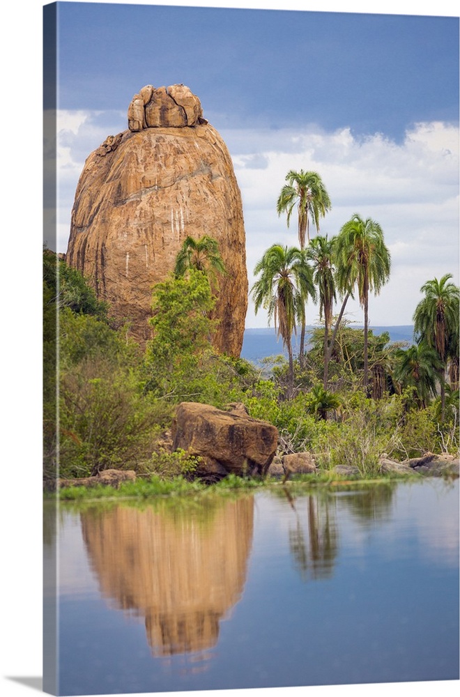 Kenya, Laikipia County, Suiyan. A large boulder reflected in the Ewuaso Narok River.