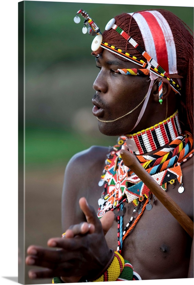 Kenya, Laikipia, Ol Malo. A Samburu warrior sings and claps during a dance.