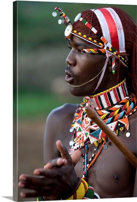 Kenya, Laikipia, Ol Malo, A Samburu warrior sings and claps during a dance