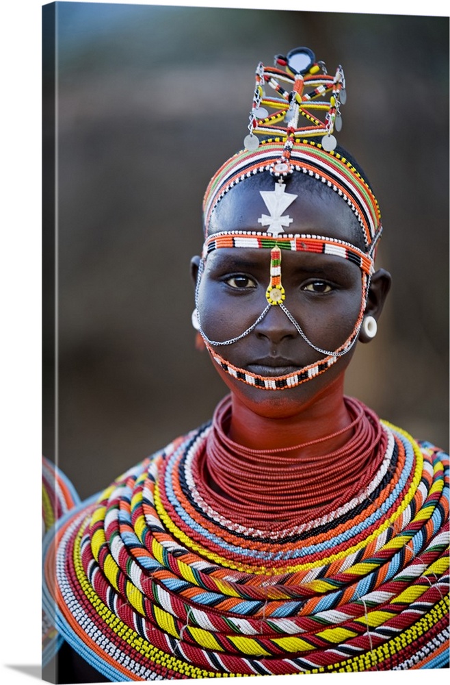 Kenya, Laikipia, Ol Malo. Young Samburu girl dressed in her traditional beaded necklaces and headress at a dance.