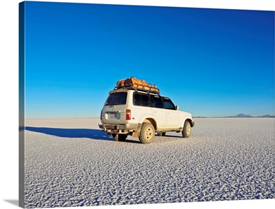 Landcruiser on the Salar de Uyuni, the largest salt flat in the world at sunset, Bolivia