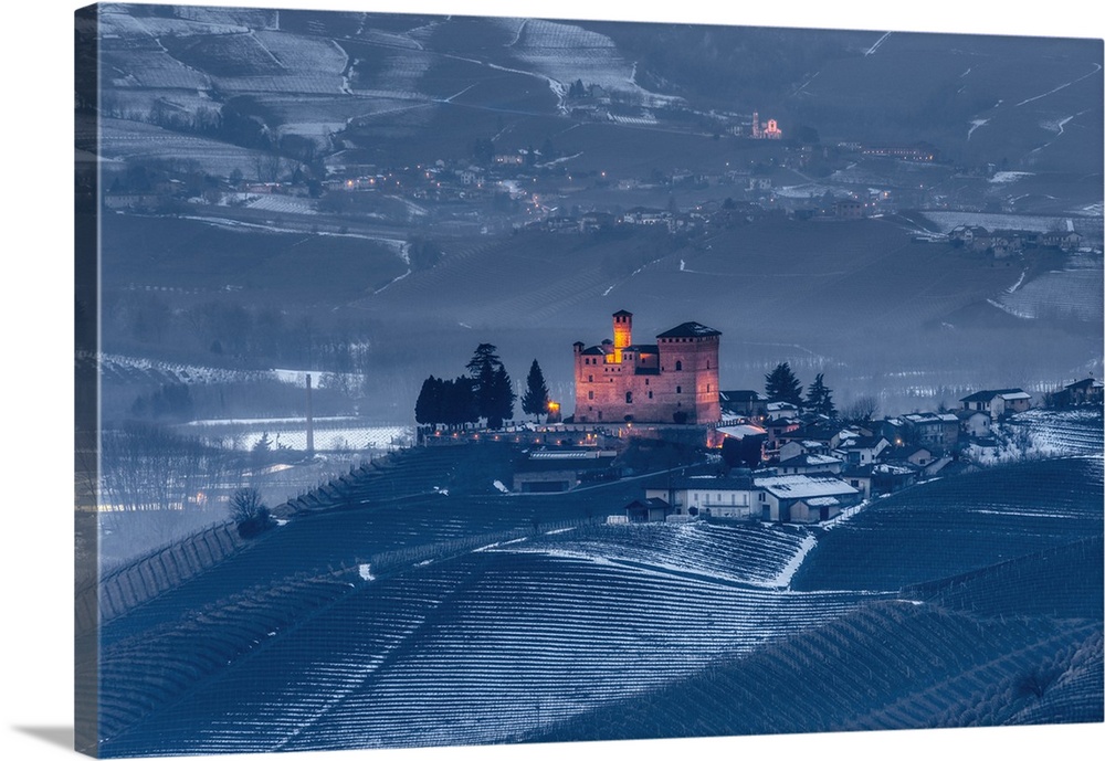 Langhe, Cuneo district, Piedmont, Italy. Langhe wine region winter snow, blue hour at the castle of Barolo
