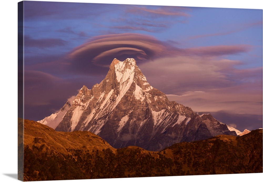 Lenticular clouds at sunset above Machapuchare, Himalayas, Nepal.