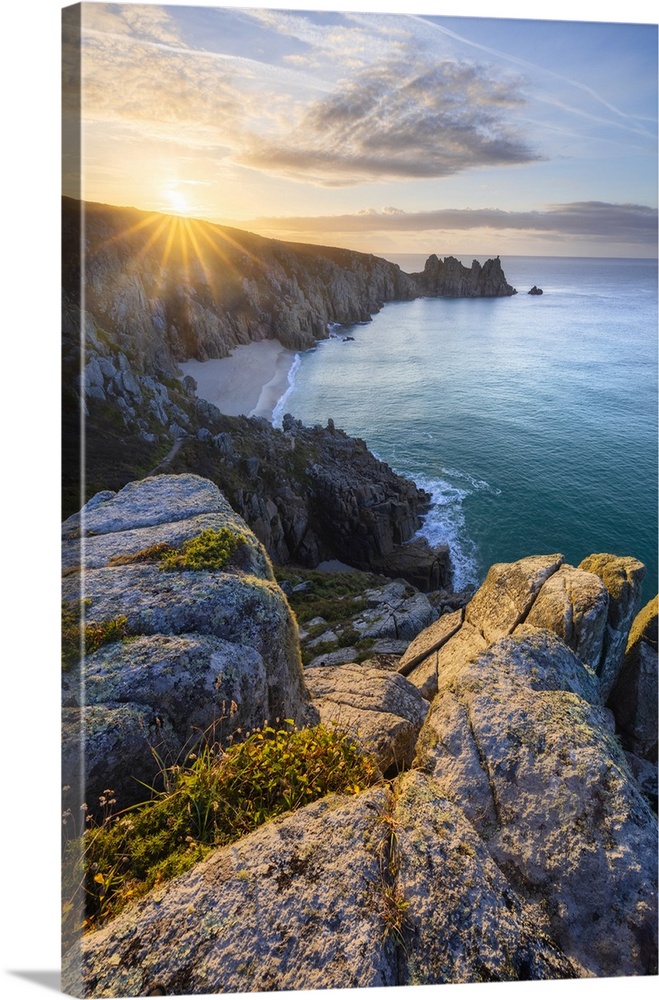 Logan Rock and Pedn Vounder beach at sunrise, St Levan, Treen, Penzance, Cornwall, England, UK