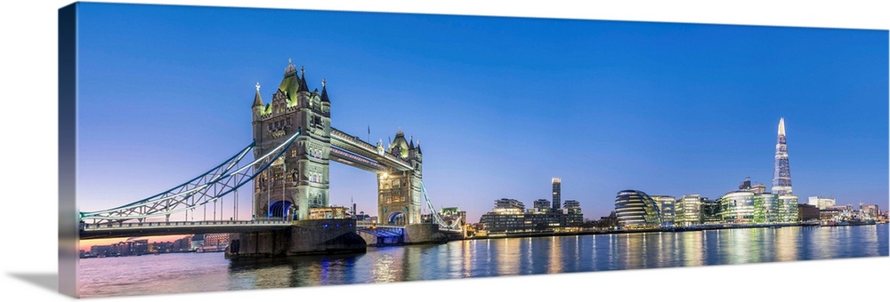 United Kingdom, England, London. Tower Bridge and modern skyline of Southwark on the River Thames at dawn.