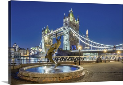London, Tower Bridge over the River Thames and 'Girl With a Dolphin' fountain at dawn
