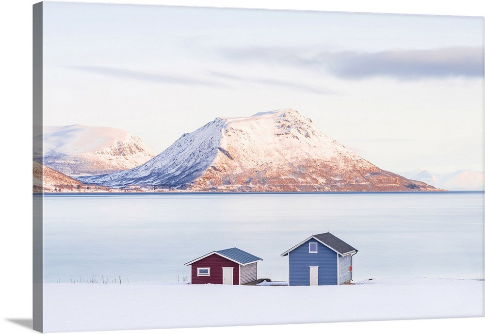 Lone Cabins On A Frozen Snowy Beach Along The Fjord At Dawn, Tromso, Norway