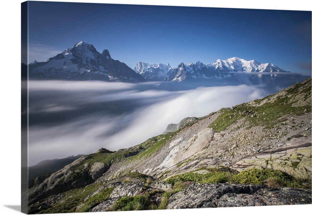 Low clouds and mist frame the snowy peaks of Mont Blanc and Aiguille Verte, Chamonix, Haute Savoie, France, Europe.