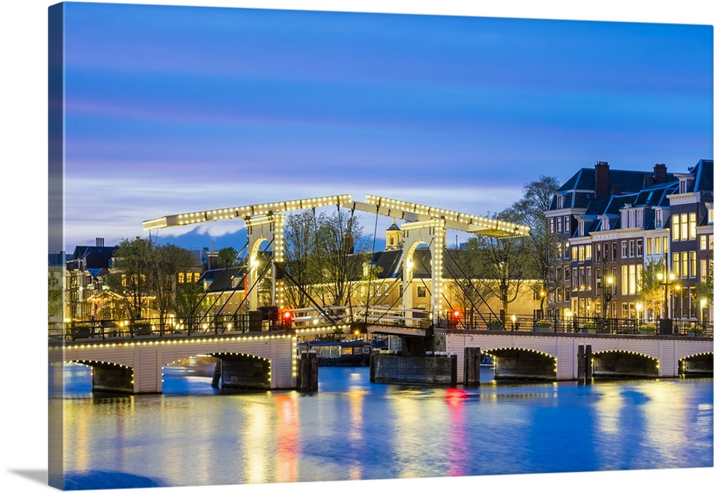 Netherlands, North Holland, Amsterdam. Magere Brug, Skinny Bridge, on the Amstel River at night.