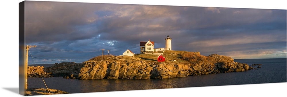 USA, Maine, York Beach, Nubble Light Lighthouse with Christmas decorations, sunset.