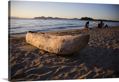 Malawi, Monkey Bay, An old dug-out canoe pulled up on to the beach of Lake Malawi