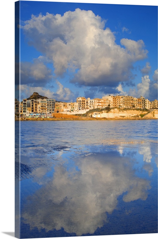 Maltese Islands, Gozo, Southern Europe. Sea clouds and houses in Marsalforn.