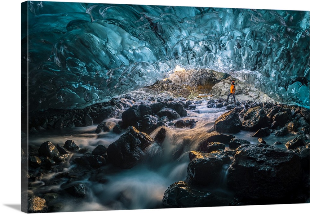 Vatnajokull glacier, Eastern Iceland, Iceland, Northern Europe. Man standing still at the entrance of a a crystal ice cave...