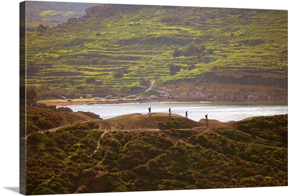 Mediterranean Europe, Malta. Hikers walking on top of clay cliffs in between gnejna and Golden Bay.