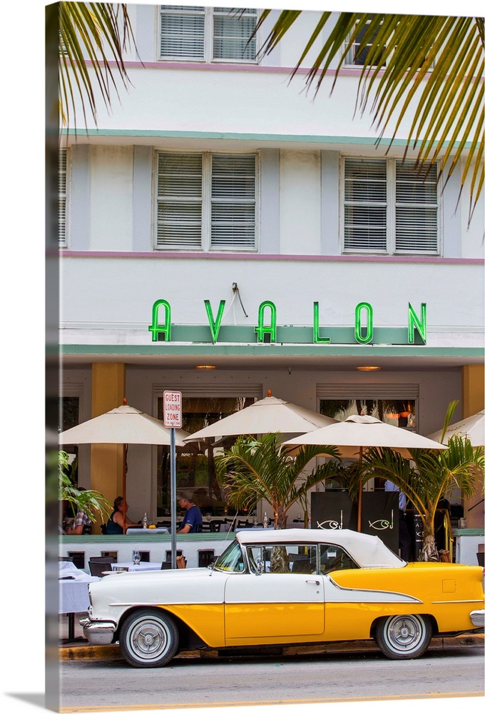 U. S. A, Miami, Miami Beach, South Beach, Ocean Drive, Yellow and white vintage car parked outside Avalon Hotel.
