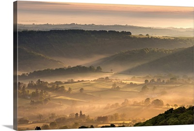 Mist covered rolling countryside at dawn, Dartmoor National Park, Devon, England