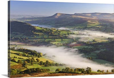 Mist covered rolling countryside backed by the Black Mountains, Brecon Beacons, Wales