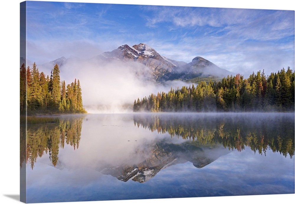 Mist obscures Pyramid Mountain, reflected in Pyramid Lake in the Canadian Rockies, Jasper National Park, Alberta, Canada. ...