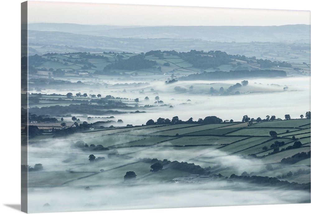 Mist over countryside at dawn near Brecon, Powys, Wales, UK.