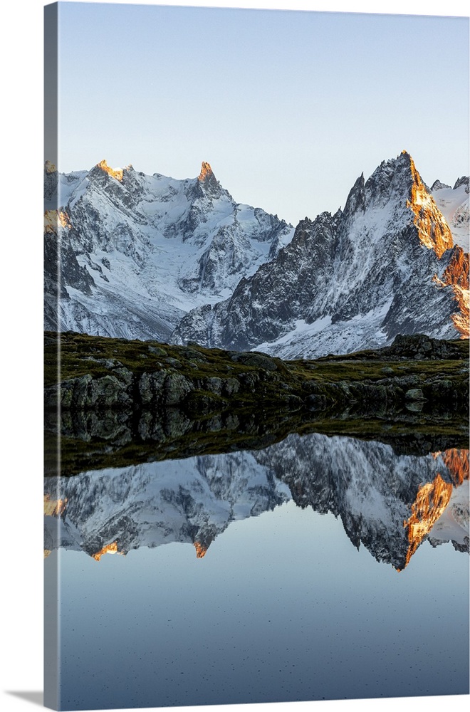 Majestic snowy Mont Blanc Massif and Dent du Geant mirrored in Lacs des Cheserys at sunset, Chamonix, Haute Savoie, France