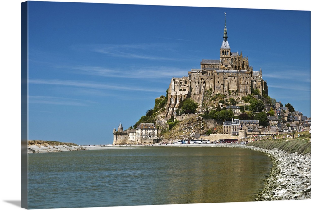 Mont Saint Michel and its connection to the mainland via a tidal causeway with the River Couesnon on the left at high tide...